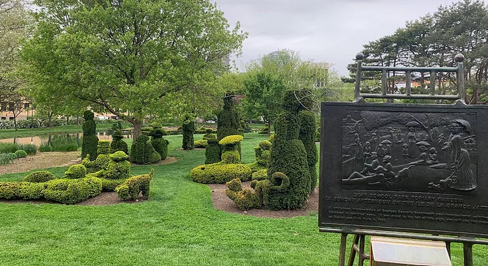 Enchanting park scene showcasing beautifully manicured topiary sculptures, lush green lawns, and a serene setting perfect for relaxation.