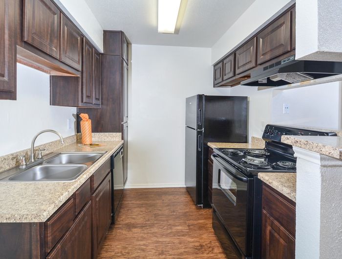 Galley Kitchen | Black Appliances | Cherry Cabinets
