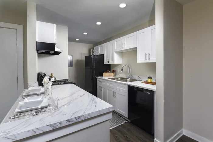 Kitchen | White Cabinets | Black Appliances | White and Gray Countertops