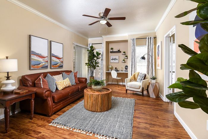 Living area | built in desk | sliding door | plank flooring | couch, chair, end table and coffee table
