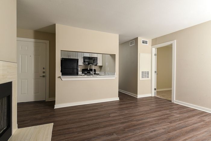 Designer home | One Bedroom | plank flooring | fireplace | kitchen with pass through
