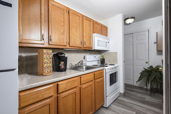 One Bedroom JR | Kitchen with oak cabinets and white appliances