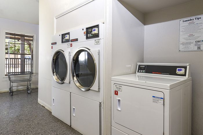 Laundry room | 2 large washer and a smaller dryer
