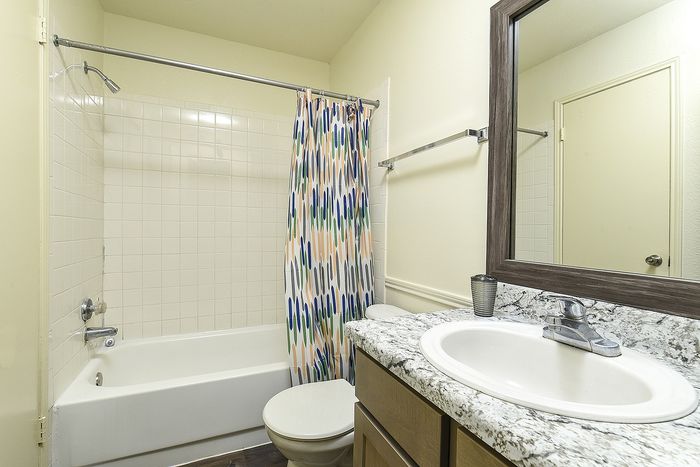 Bathroom | Vanity, toilet and tiled tub area