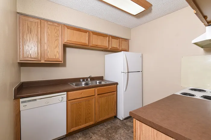 Kitchen with oak cabinets and white appliances