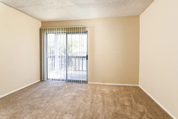 Living area with sliding glass door that leads out to the balcony
