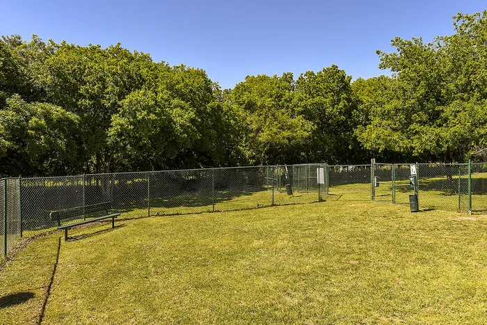 dog park with bench and waste collection bins