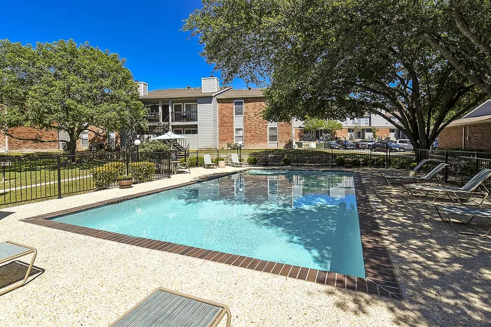 One of the 2 pools | lounge chairs and tables with chairs