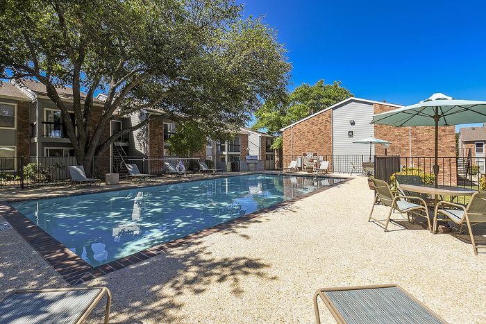 One of the 2 pools | lounge chairs and tables with chairs