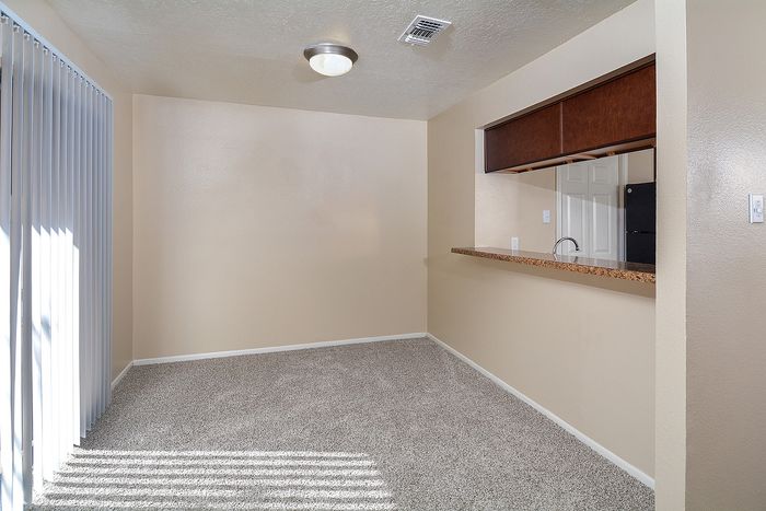 Townhome | Dining area | Pass through counter to kitchen | Sliding glass doors
