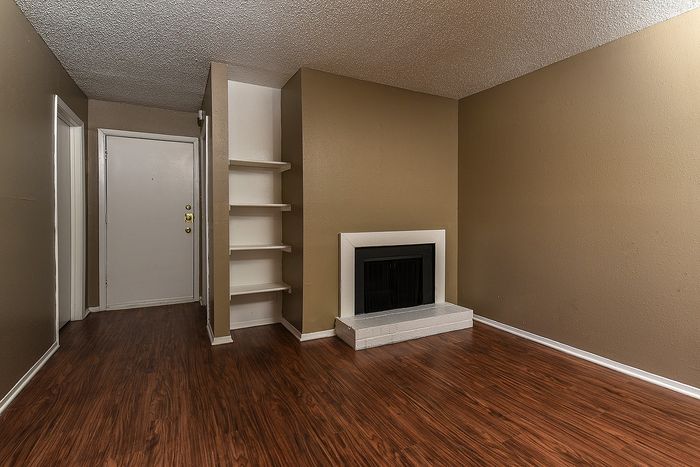 Plank flooring | Fireplace | built in shelves