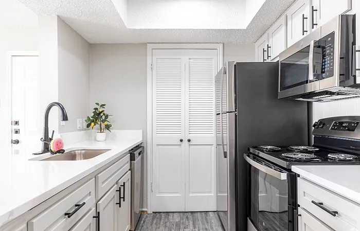 A1 Floor plan Contemporary kitchen with stainless steel appliances and elegant white cabinetry.