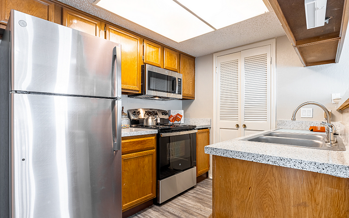 A2, Classic floor plan kitchen with stainless steel appliances and wood cabinetry.