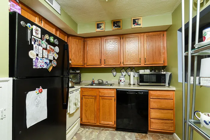 Cozy kitchen with natural wood cabinets, modern appliances, and inviting decor perfect for culinary adventures.
