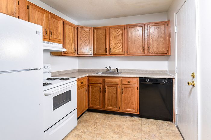 Charming kitchen with warm wooden cabinetry, modern appliances, and ample countertop space.