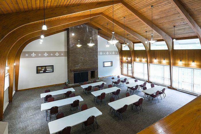 Inviting communal space with elegant wood beam ceilings, expansive windows, and versatile seating arrangements.