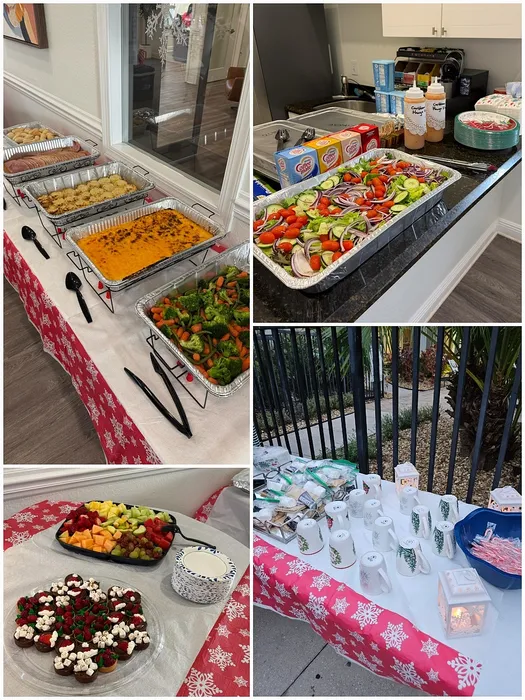 Festive event setup featuring a variety of delicious food trays, fresh vibrant salads, artisanal desserts, and a cozy coffee station with decorative mugs on a snowflake-themed tablecloth.