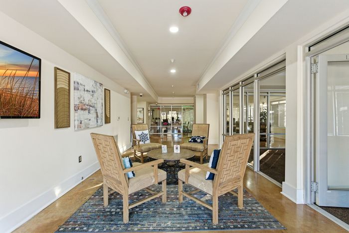 Inviting lobby area with elegant seating, modern artwork, and natural lighting, perfect for relaxation and socializing.