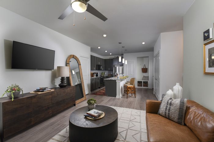 Contemporary open-concept living space with sleek kitchen, stylish decor, and cozy seating area.