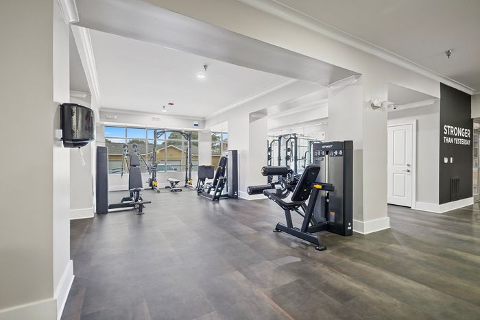 Bright and modern fitness center with state-of-the-art equipment and large windows for natural light.