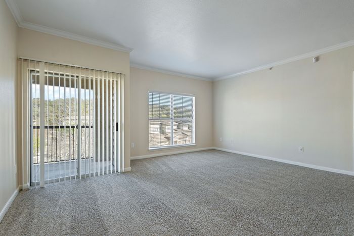 Bright and spacious living area with large windows and serene garden views.