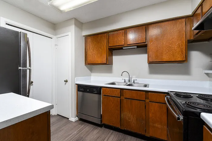 Charming kitchen with sleek countertops, modern appliances, and warm wooden cabinetry.