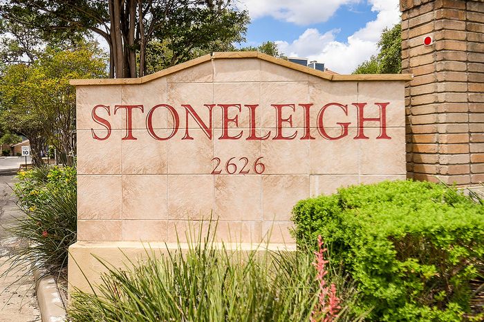Inviting entrance sign of Stoneleigh framed by lush greenery, offering a welcoming atmosphere.