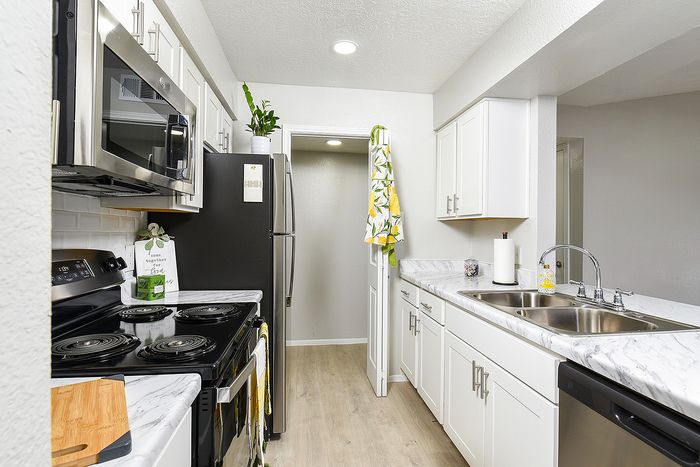 Modern kitchen with sleek countertops, stainless steel appliances, and elegant cabinetry.