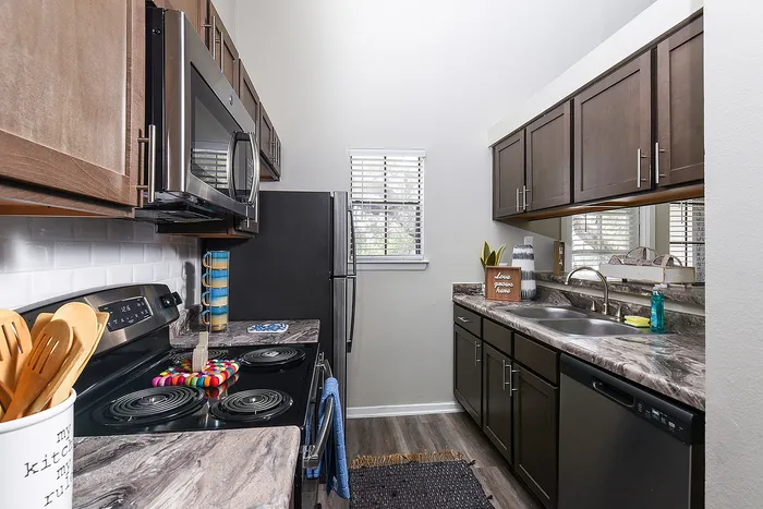 Modern kitchen with sleek cabinetry, stainless steel appliances, and elegant marble countertops, perfect for culinary enthusiasts.
