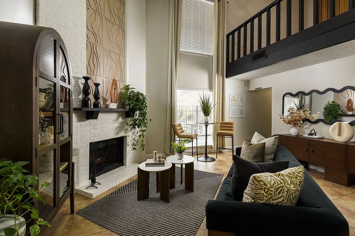 Chic and spacious living room with vaulted ceilings, elegant decor, and a cozy fireplace, ideal for relaxation and entertaining.