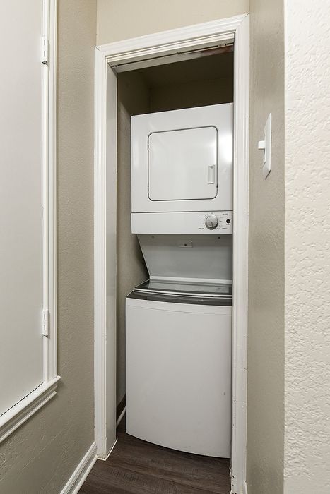 Compact laundry space featuring a modern stacked washer and dryer unit, perfect for urban living.