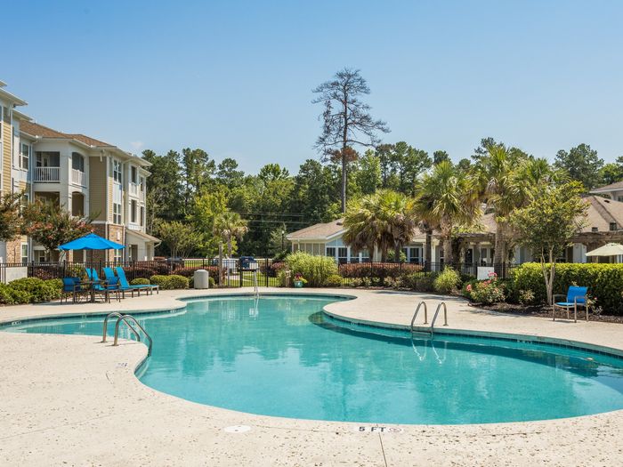 Resort-style swimming pool with sundeck at St. James at Goose Creek apartments for rent in Charleston, SC