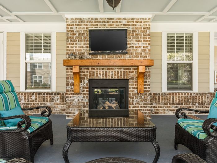 Outdoor fireside lounge with TV at St. James at Goose Creek apartments for rent in Charleston, SC