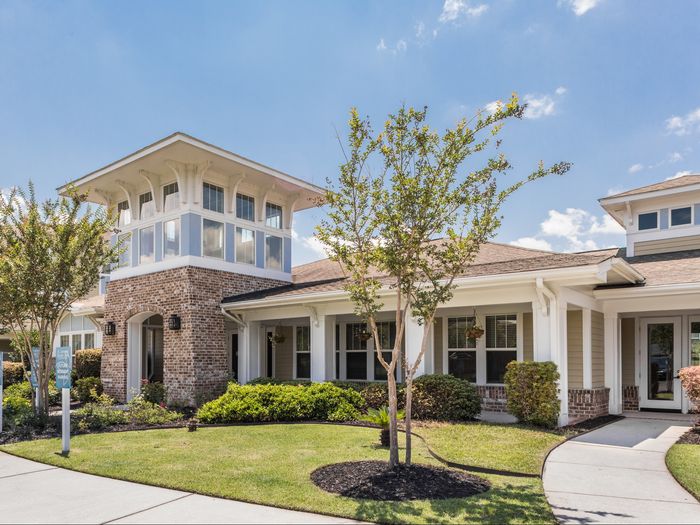 Exterior view of leasing center and clubhouse at St. James at Goose Creek apartments for rent in Charleston, SC