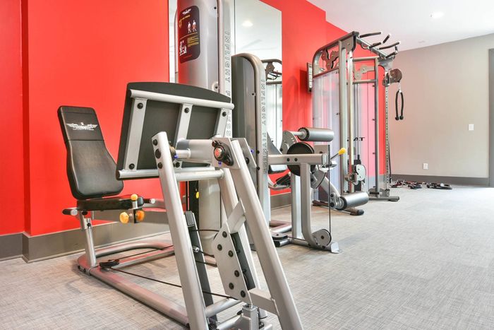 Fitness center with cardio equipment and free weights at Pointe at Canyon Ridge apartments for rent in Atlanta, GA