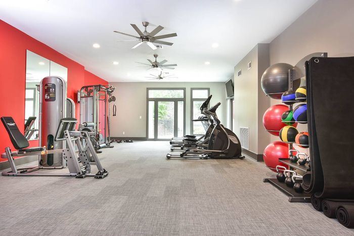 Fitness center with cardio equipment and free weights at Pointe at Canyon Ridge apartments for rent in Atlanta, GA