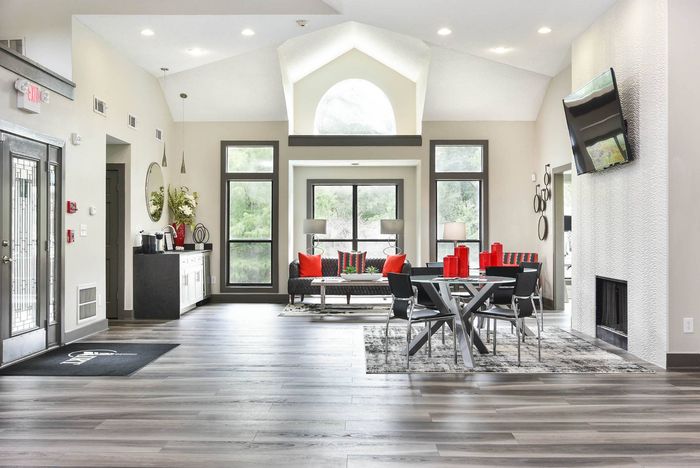 Community clubhouse with large windows, coffee station, couch and table seating at Pointe at Canyon Ridge apartments for rent in Atlanta, GA