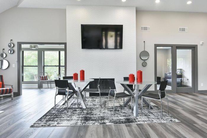 Clubhouse seating area with TV at Pointe at Canyon Ridge apartments for rent