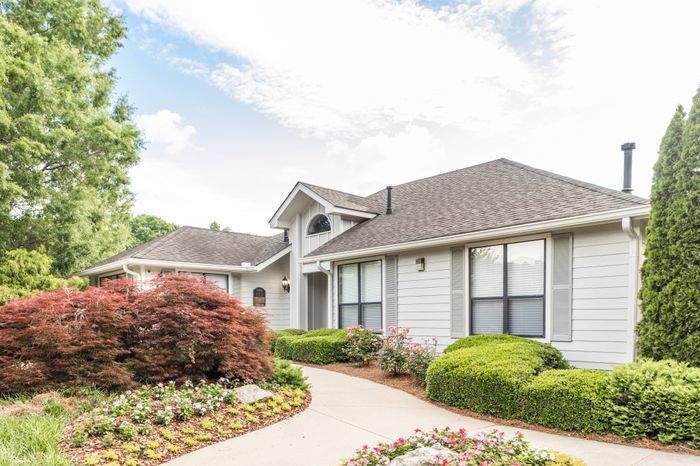 Exterior of leasing center with beautiful landscaping at Pointe at Canyon Ridge apartments for rent in Atlanta, GA