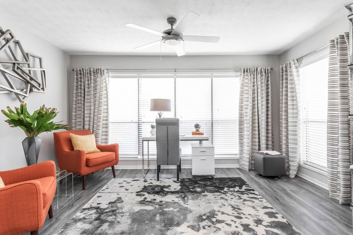 Living area with large windows for natural light and lofty 9-ft. ceilings at Pointe at Canyon Ridge apartments for rent