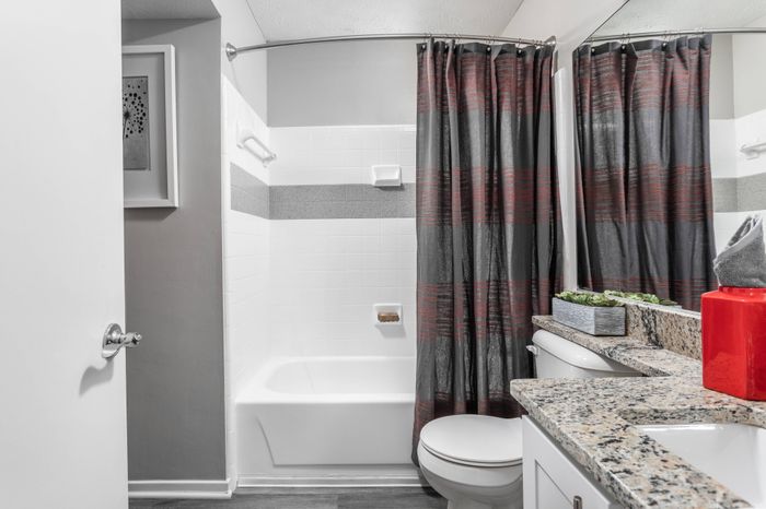 Bathroom with granite countertops and garden-style tub at Pointe at Canyon Ridge apartments for rent in Atlanta, GA