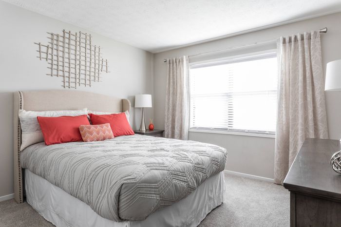 Furnished bedroom with lofty 9-ft. ceilings and windows for natural light at Pointe at Canyon Ridge apartments for rent in Atlanta, GA