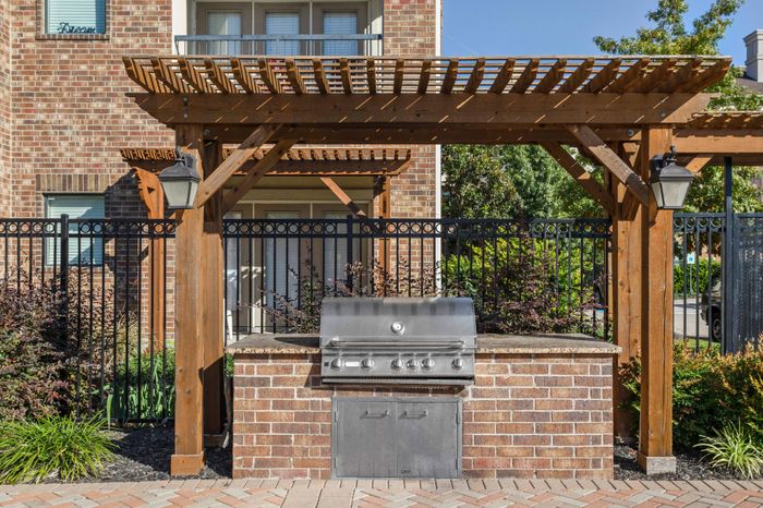 Gas grill area under pergola at Avenues at Craig Ranch apartments for rent in Dallas, TX