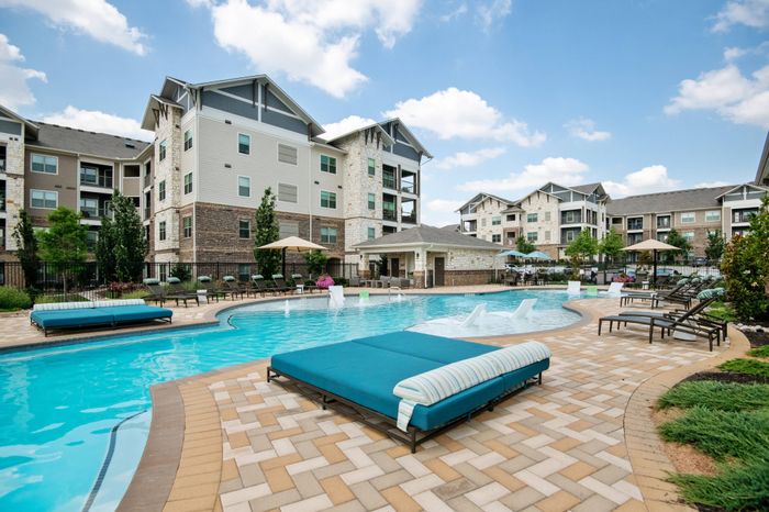 Salt water swimming pool with sundeck and cabana at The Adley Craig Ranch apartments for rent