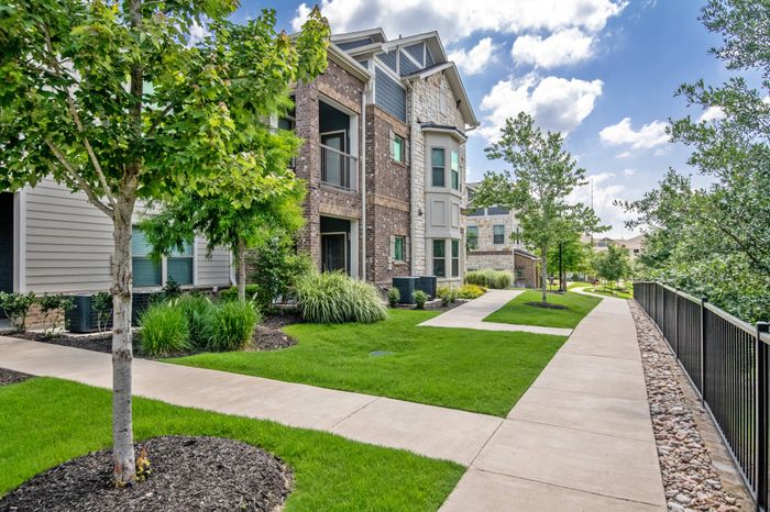 Exterior view of residential buildings at The Adley Craig Ranch apartments for rent in McKinney, TX