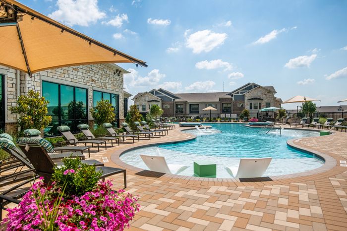 Lounge seating in pool area at The Adley Craig Ranch apartments for rent in McKinney, TX