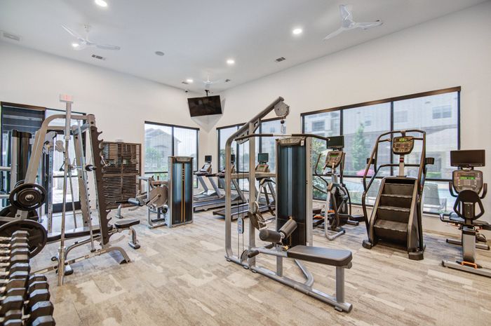 24-hour fitness center with cardio and training equipment at The Adley Craig Ranch apartments for rent