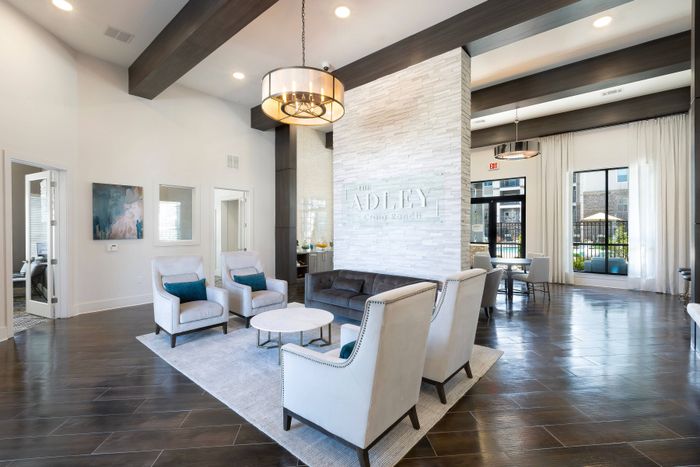 Large community clubhouse with ample seating at The Adley Craig Ranch apartments for rent in McKinney, TX