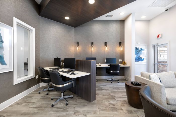 Multiple workstations in business center with free WiFi available at The Adley Craig Ranch apartments for rent