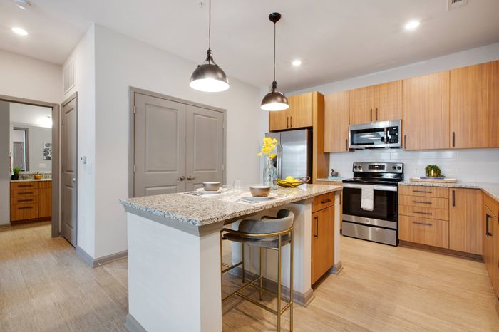 Kitchen with subway tile backsplash and spacious white granite countertops at Solis City Park apartments for rent